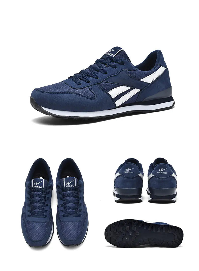 Herrenfreizeitsneaker in Grau und Weiß zum Gehen mit marineblauem sportlichem Sneaker-Design, weißen Akzenten und einem strukturierten Obermaterial.