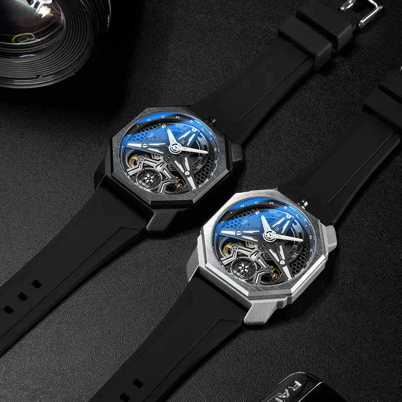 Two automatic skeleton mechanical watches for men featuring octagonal blue dials with visible movements and black rubber straps in matte black and silver-toned metal casings
