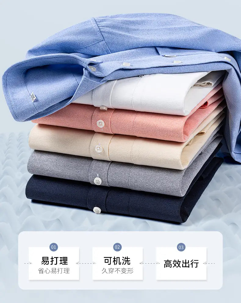 Stack of neatly folded men cotton oxford long sleeve casual shirts in soft pastel and neutral tones featuring classic button-down collars and crisp fabric.