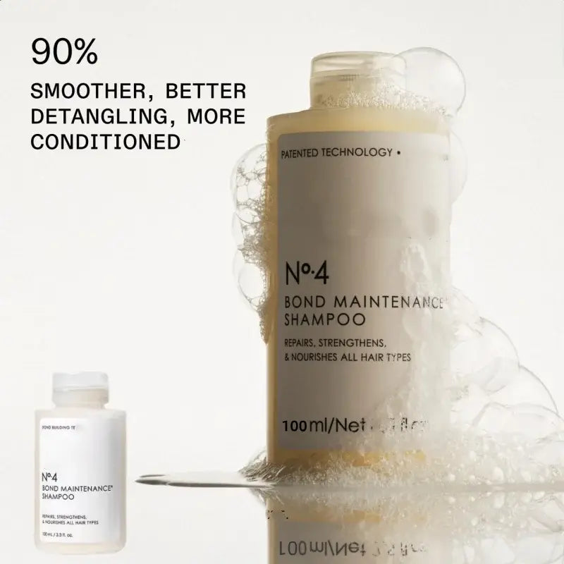 a sleek transparent bottle of nº4 bond maintenance shampoo with a minimalist white label and gold-toned cap from the hair care series for control frizz repair and frizz repair split ends.