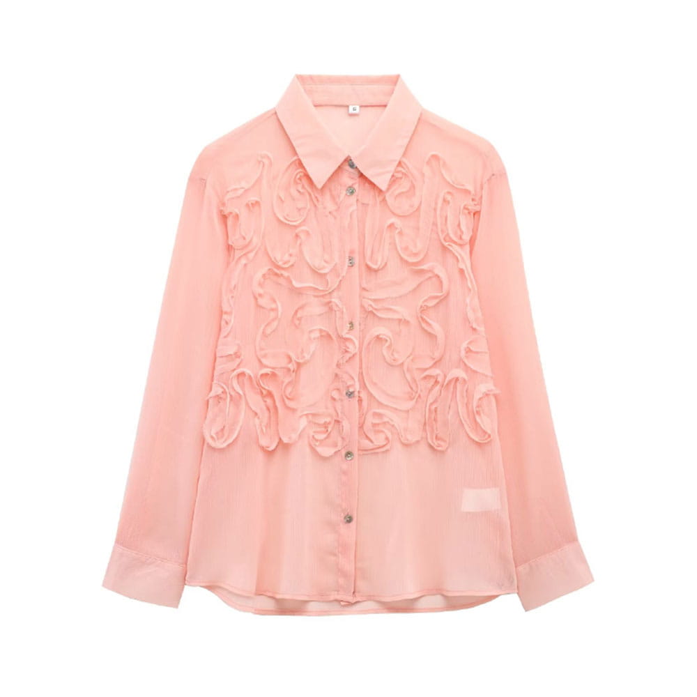 A delicate pink sheer blouse made of textured fabric with intricate ruffled floral appliqués across the front.