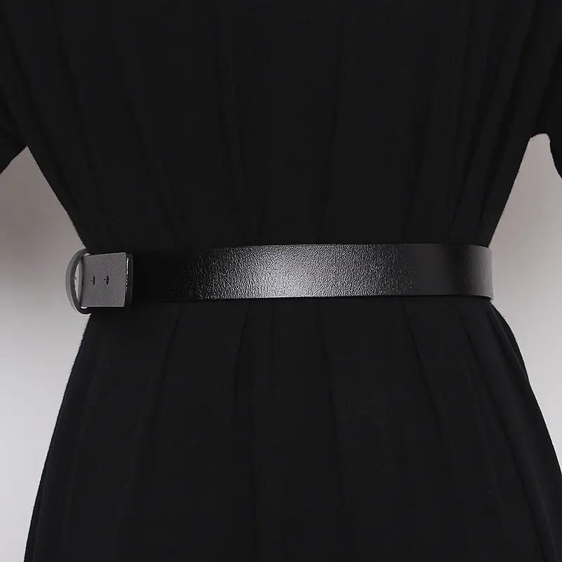 Black leather belt for women with a gold horsebit matte-finished metal buckle and sleek minimalist design.