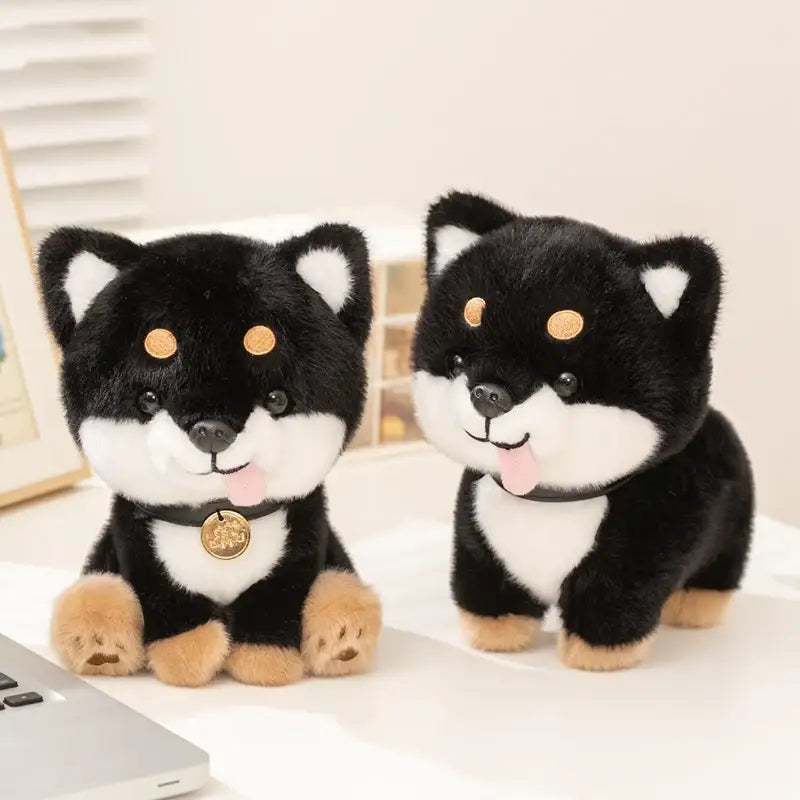 Adorable black and white shiba inu plush toys with tan paws gold button eyes and a dangling golden tag on their collars made as stuffed animal dog toys.
