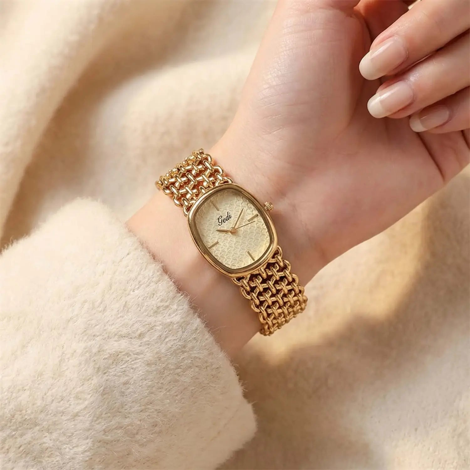 Gold-toned gedi watch featuring a textured cream-colored dial and an intricate mesh bracelet in an elegant quartz bracelet timepiece design.