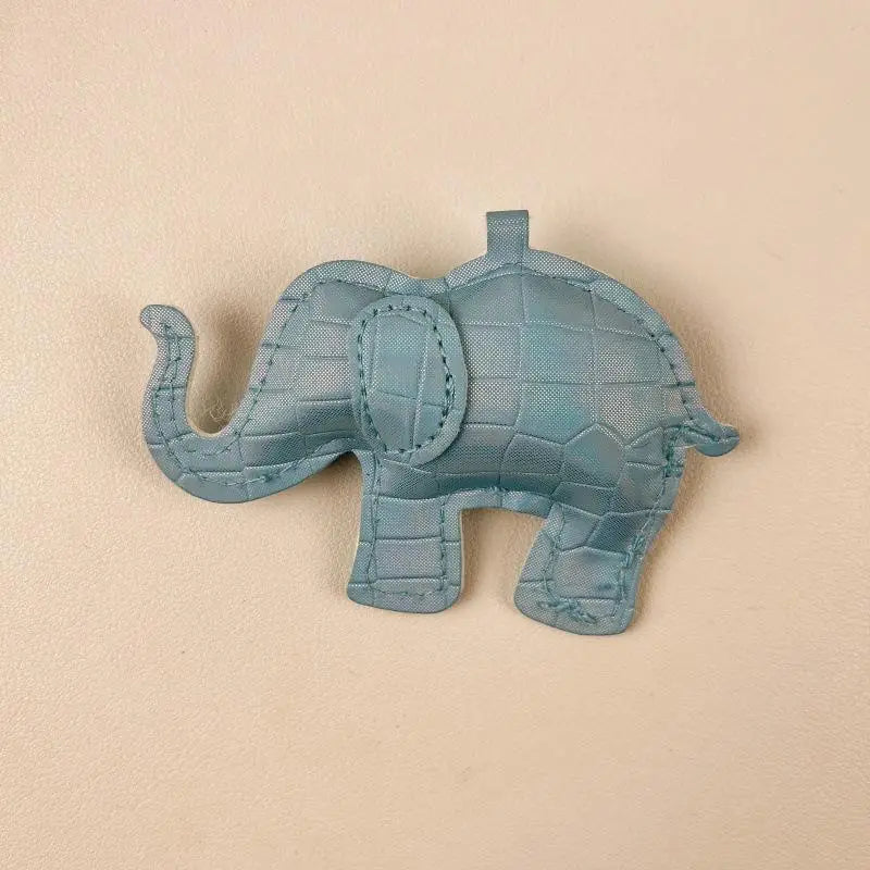 A light blue quilted pu leather elephant-shaped keychain with crocodile-patterned texture and stitched details for diy animal charm use.