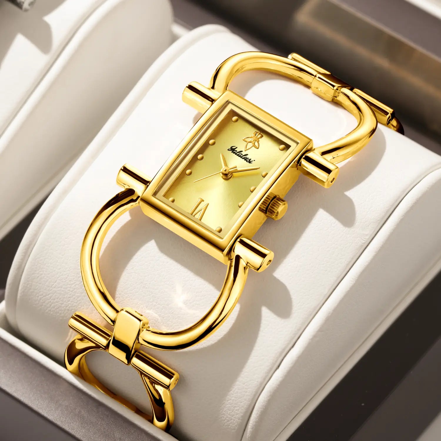 Gold luxury quartz women watch bracelet featuring a gold-toned rectangular case with a distinctive horsebit-style bracelet and minimalist dial.