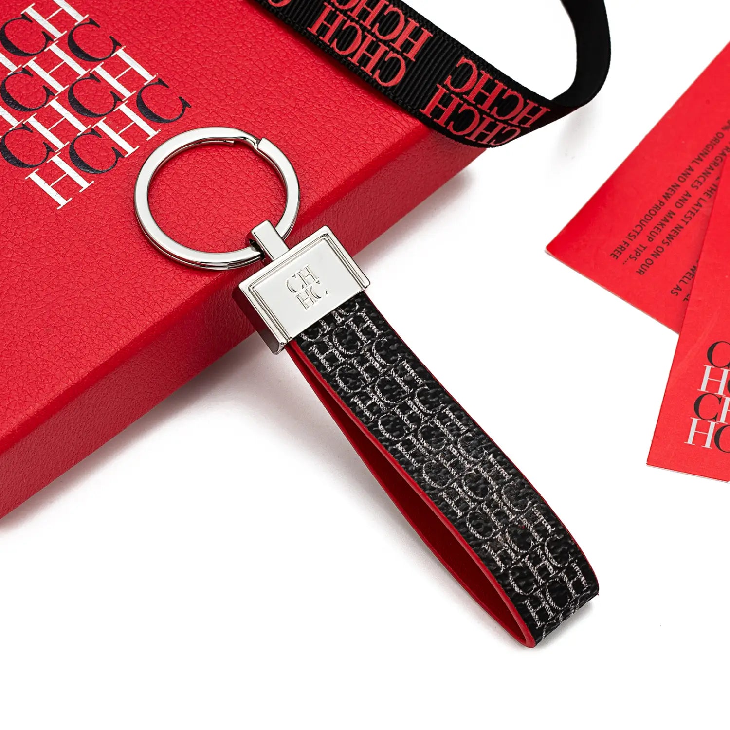Black and silver leather logo keychain featuring a metallic rectangular plate with the ch logo designed as a fashion accessory gift.