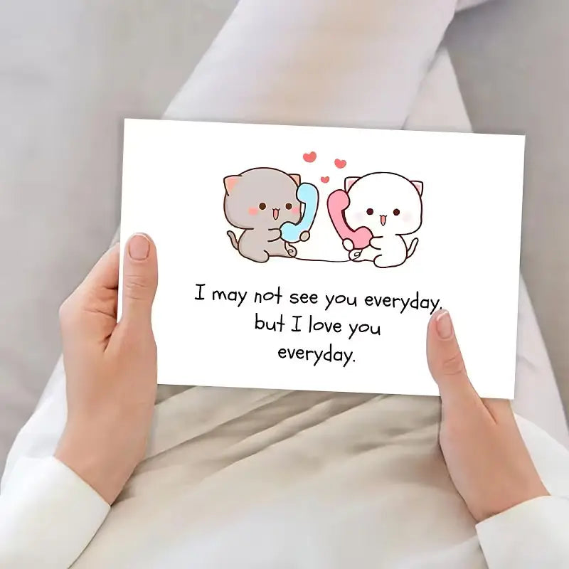 Une carte de vœux rectangulaire pour couple de chats à longue distance blanche présente deux adorables chats dessinés tenant des téléphones colorés, avec le texte : je ne vous verrai peut-être pas tous les jours, mais je vous aime tous les jours.