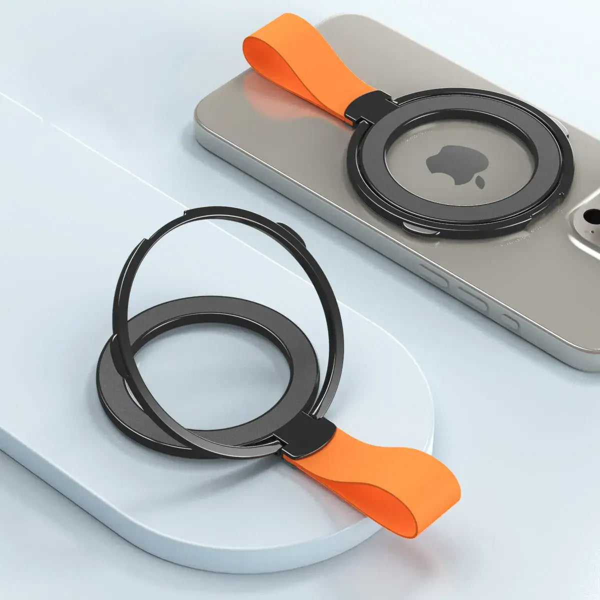 Black magnetic phone ring holder with orange silicone strap shown from the back side designed for Magsafe compatibility.
