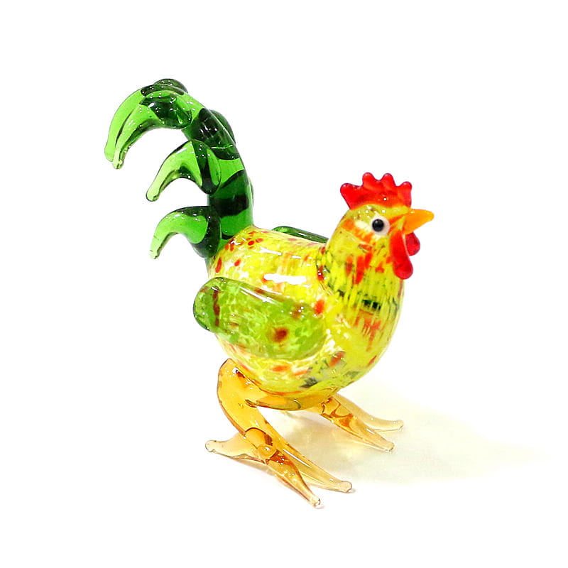 Vibrant glass rooster miniature figurine with a yellow-green speckled body, green tail feathers, and orange legs designed as an Easter ornament.