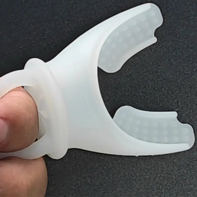 white silicone finger grip with textured rounded prongs for secure holding attached to lung capacity training device respiratory fitness tool