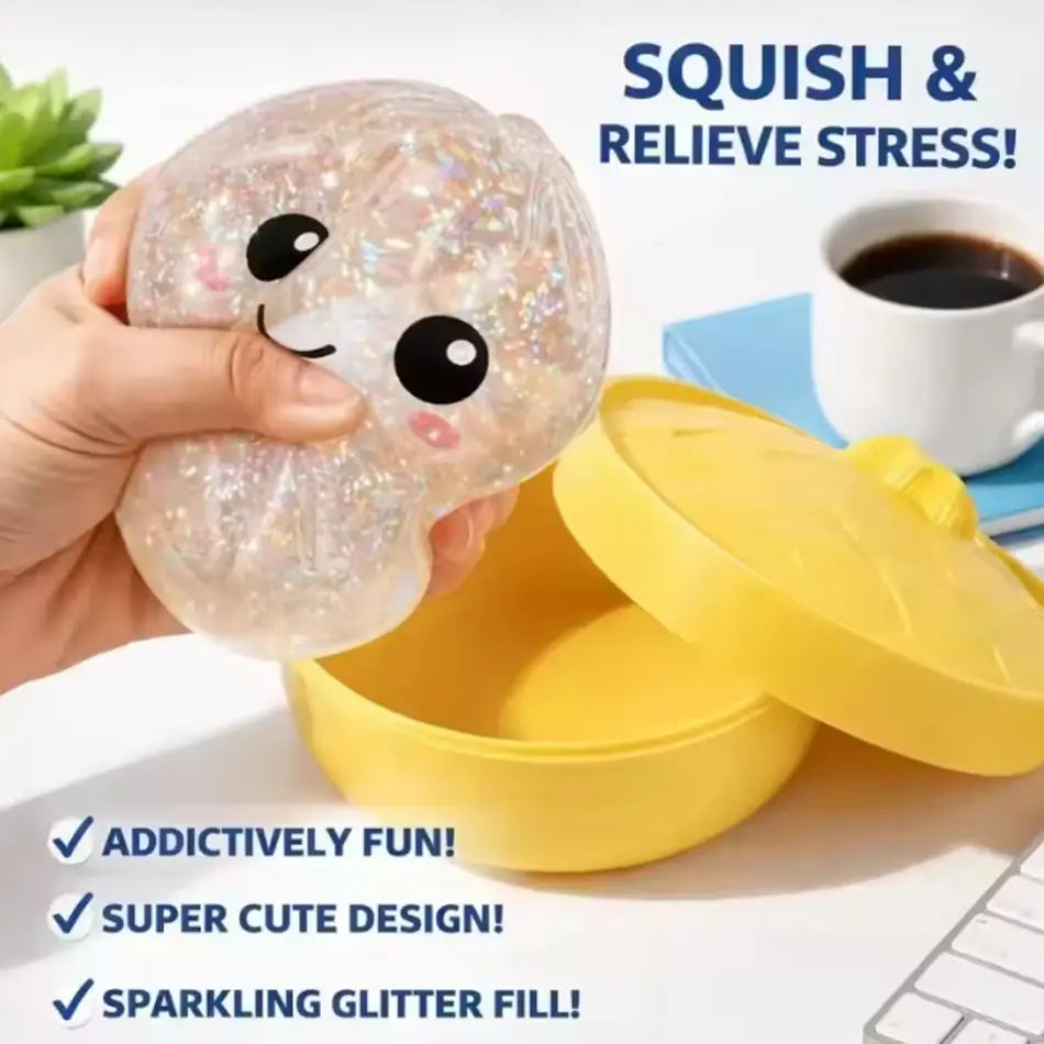 A transparent glitter dumpling squishy stress relief toy filled with silver glitter and featuring a cute cartoon face design viewed from the front.