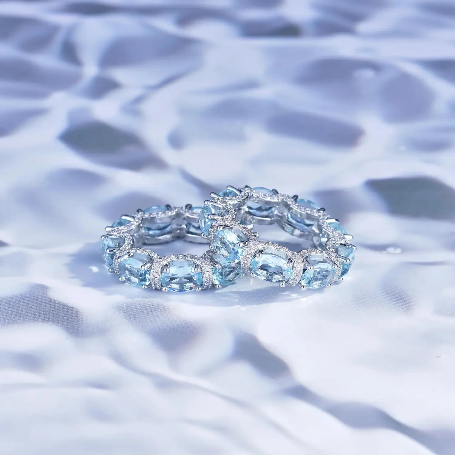 Elegant blue topaz and diamond eternity band ring with sleek silver setting from the aquamarine crystal bridal jewelry set.
