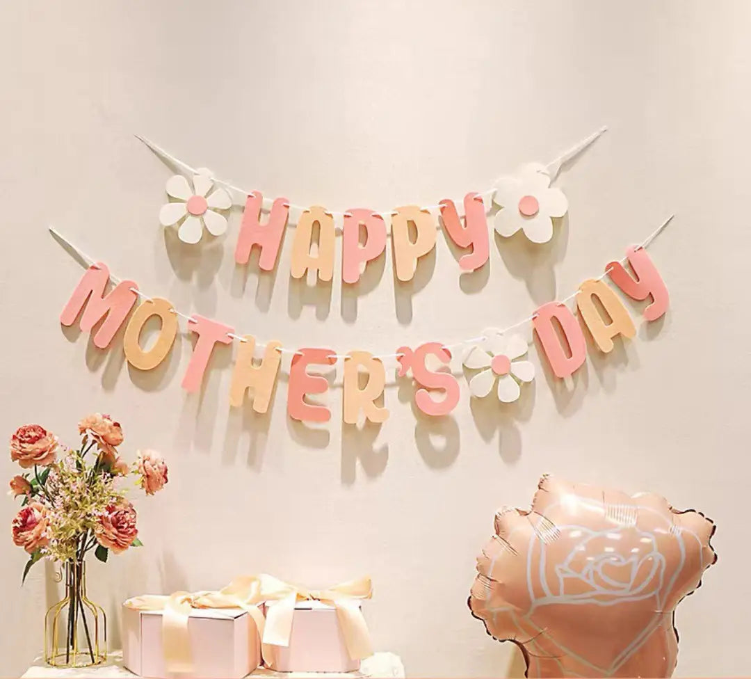 pastel pink and peach gradient paper banner with happy mothers day lettering and white flower accents for mothers day daisy paper banner wall decor