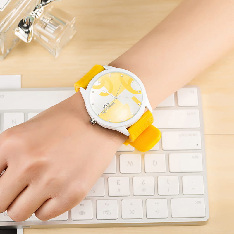 Yellow silicone strap womage silicone quartz women sports watch with a white face and yellow abstract design.