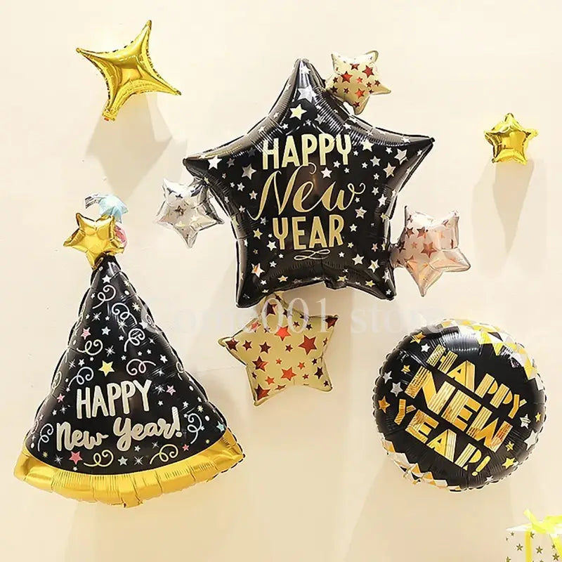Globos de lámina para "Happy New Year" en negro y dorado con patrones de estrellas para juego de decoración de fiesta.