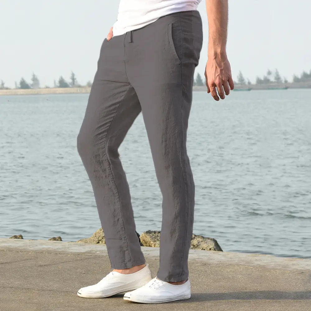 Gray cotton linen chino pants with a slim fit and subtle side seam detailing designed as breathable casual men trousers.