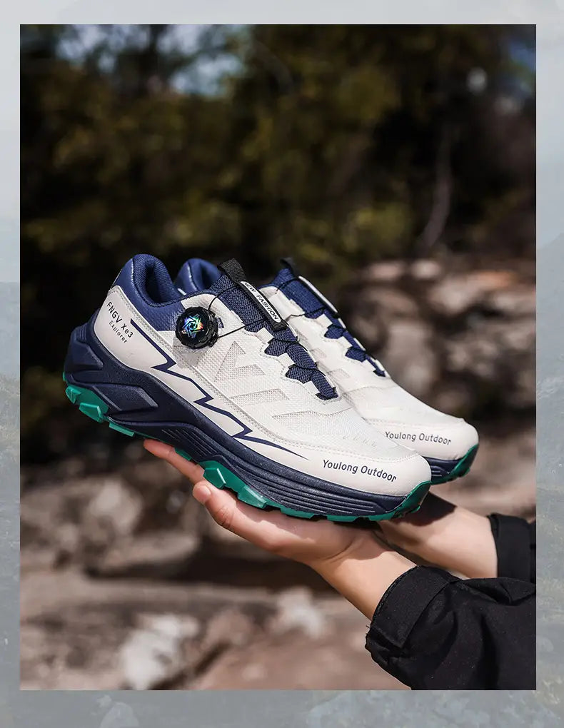 Men hiking shoes waterproof lightweight trekking sneakers in white and navy blue with teal accents featuring a breathable mesh upper and a distinctive circular dial closure system.