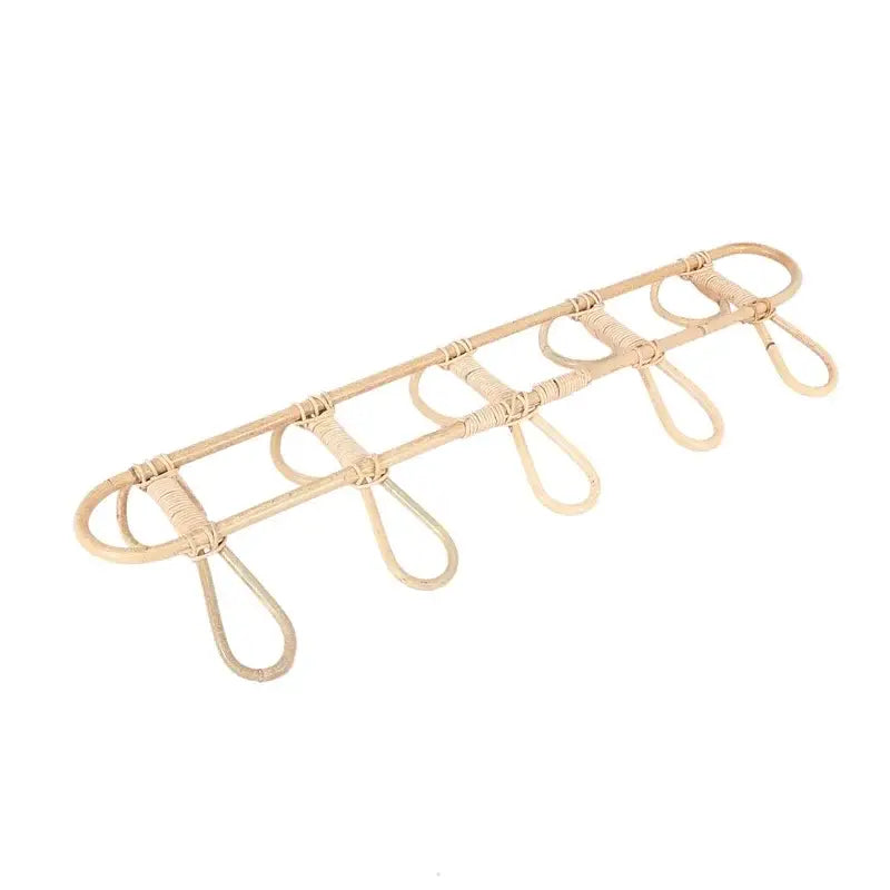 Natural beige rattan 5 hook kids wall hanger organizer with five evenly spaced loops for organizing keys or small items.