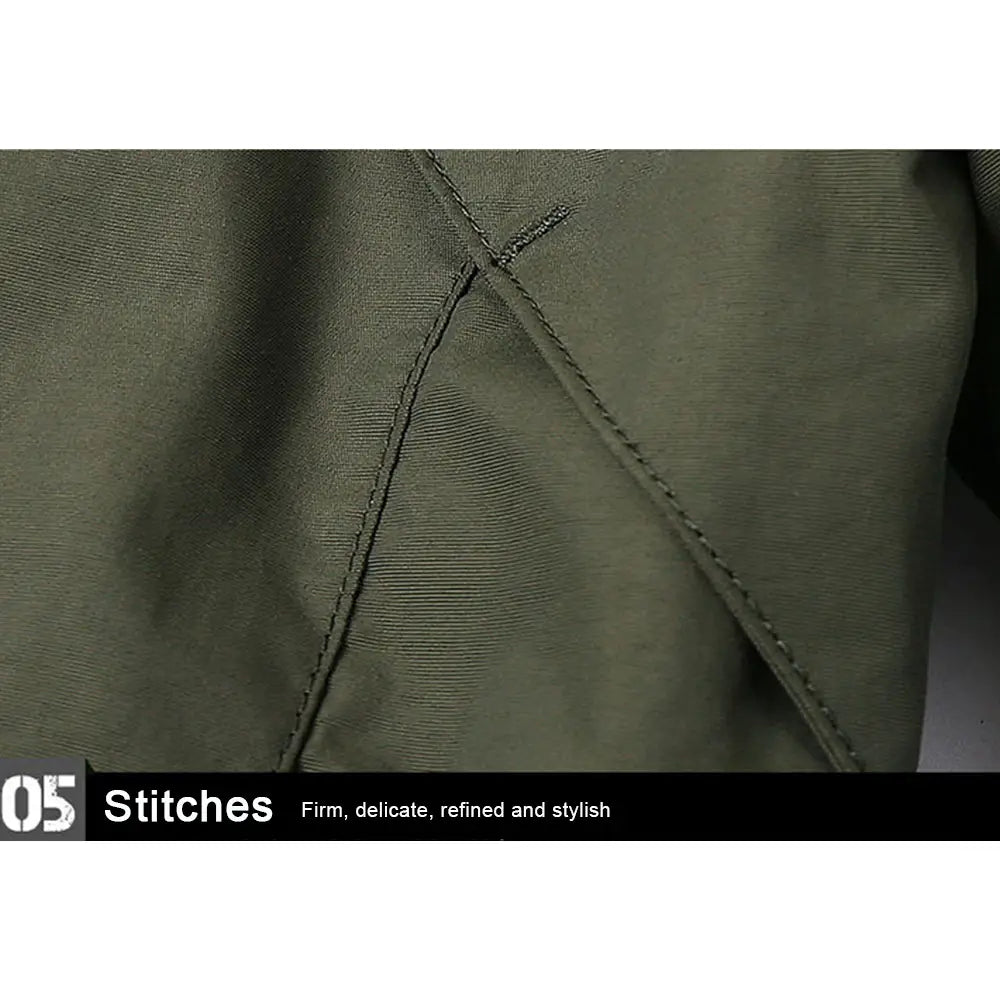 olive green waterproof tactical hooded jacket fabric with precise firm stitching highlighting durability and quality.