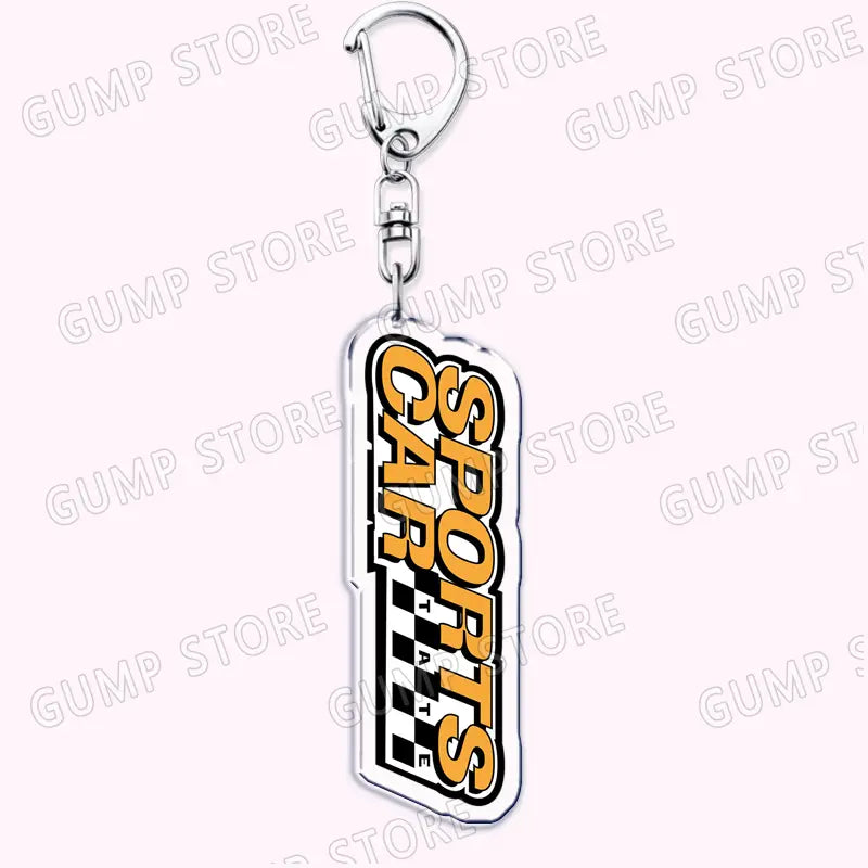 A sleek transparent acrylic keychain for music fans featuring bold orange and black sports cars lettering with a checkered flag design from the Tate Mcrae collection.