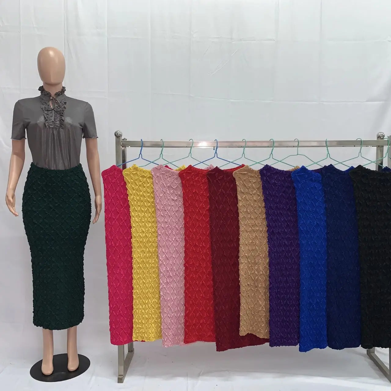 a collection of vibrant high waist knit midi skirts in slim fit design featuring textured fabric in pink yellow red and blue colors