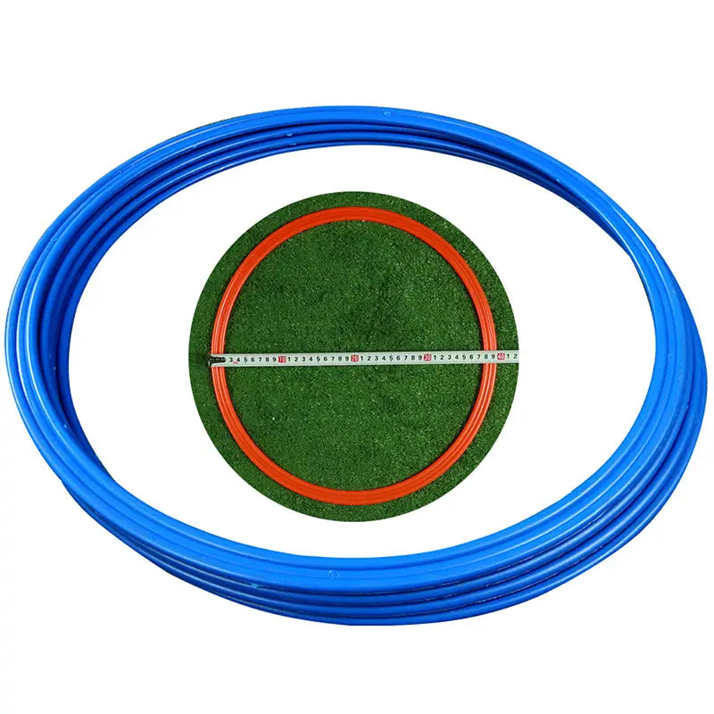 Blue plastic agility training ring with orange inner rim and green artificial turf center featuring measurement markings for soccer speed exercise equipment.