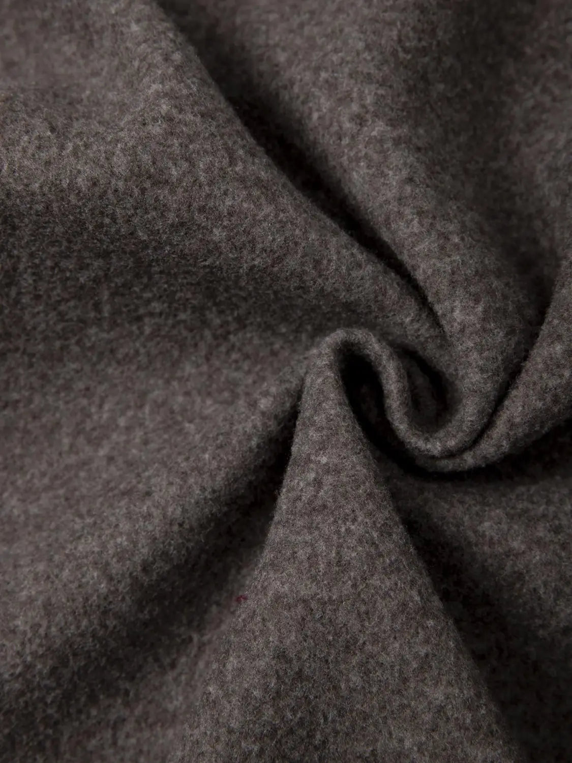dark gray woolen fabric with a soft textured weave featured in a men’s fleece lined knit hooded jacket