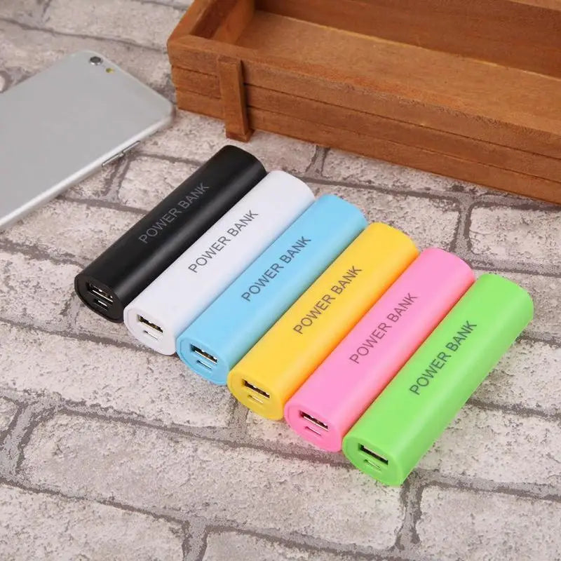 A set of six colorful cylindrical portable 18650 power bank cases in black white light blue yellow pink and green each with power bank printed on the side for diy shell charger use.