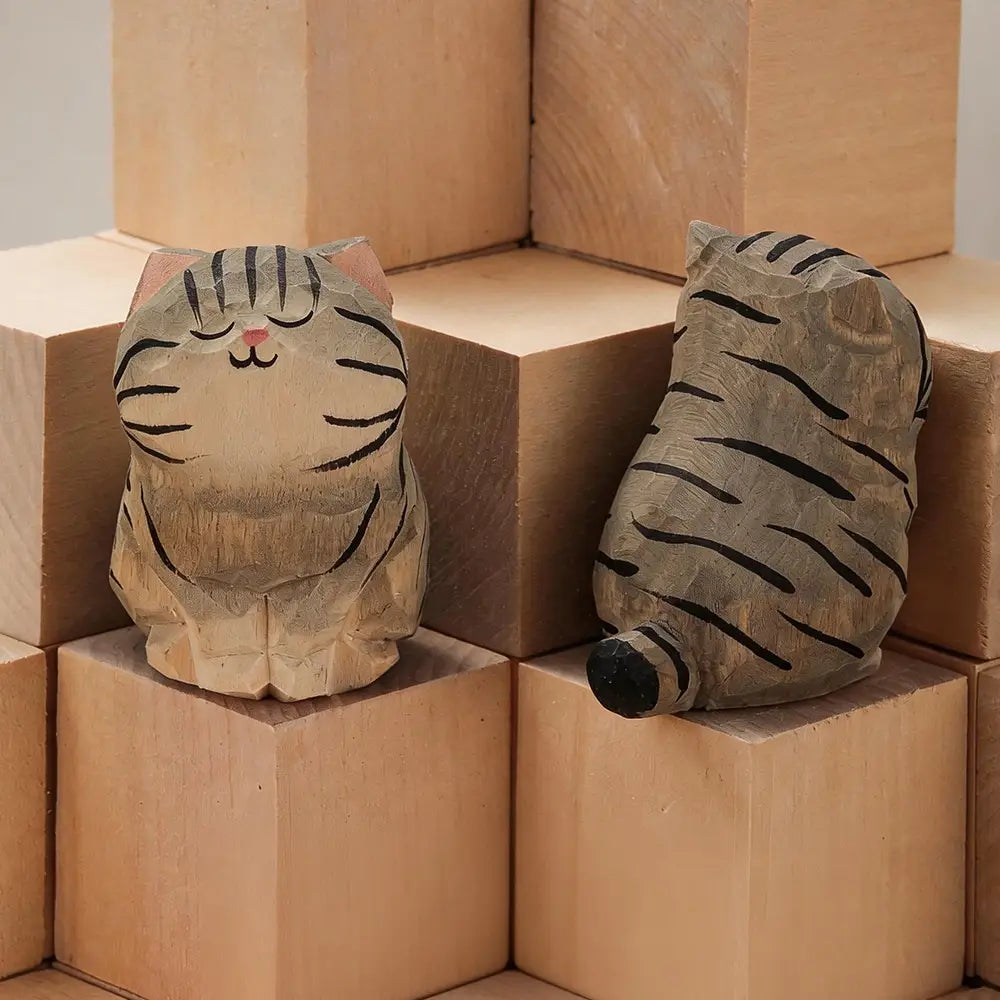 Handcrafted wooden cat figurine desk decor featuring hand-carved wooden cats with black stripes and pink accents in sitting and lying down poses offered factory direct as actual product.