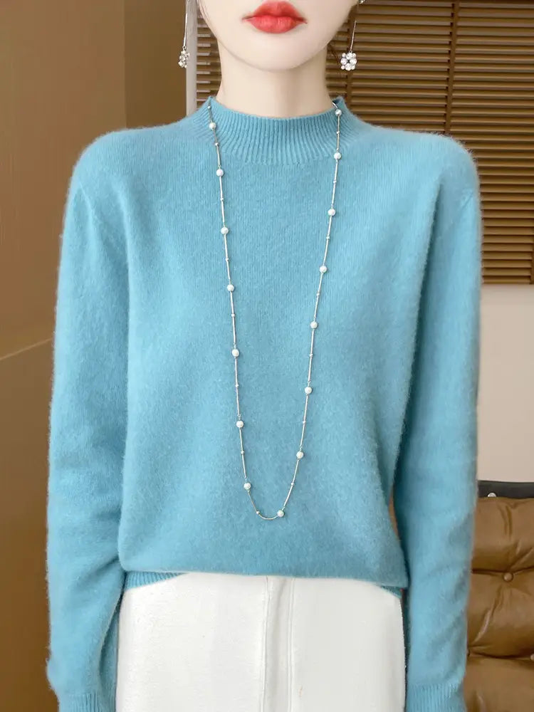 Light blue merino wool pullover sweater for women featuring a soft-knit fabric and long sleeves with a turtleneck design.