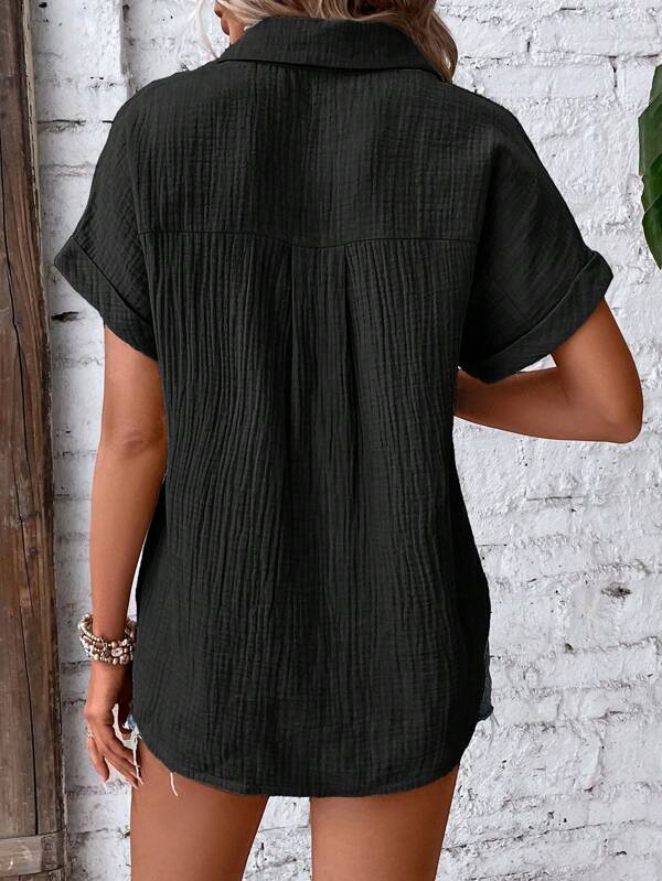 black cotton short sleeve button up shirt dress with a collar and vertical pleats designed for women