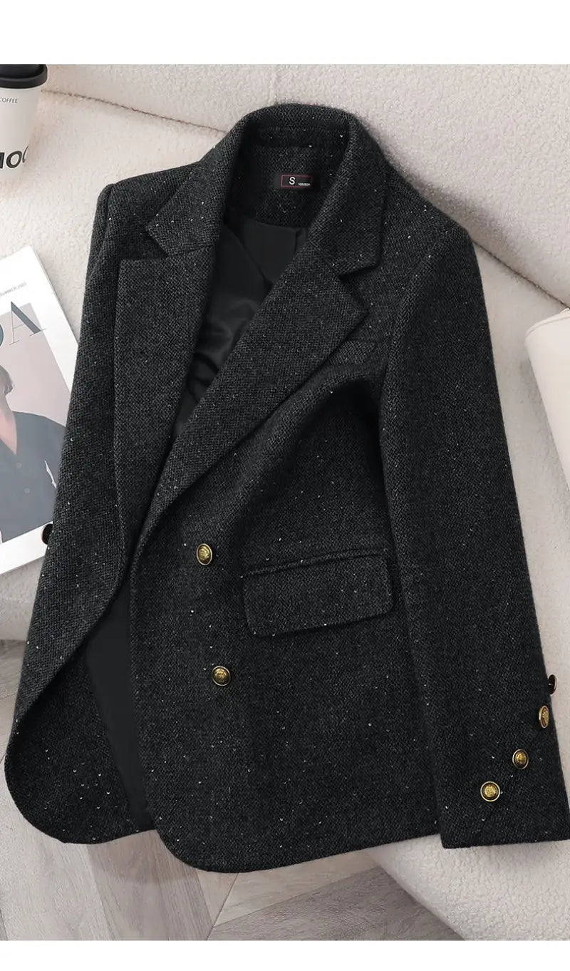 Black wool blend double breasted blazer with textured fabric and gold toned buttons.