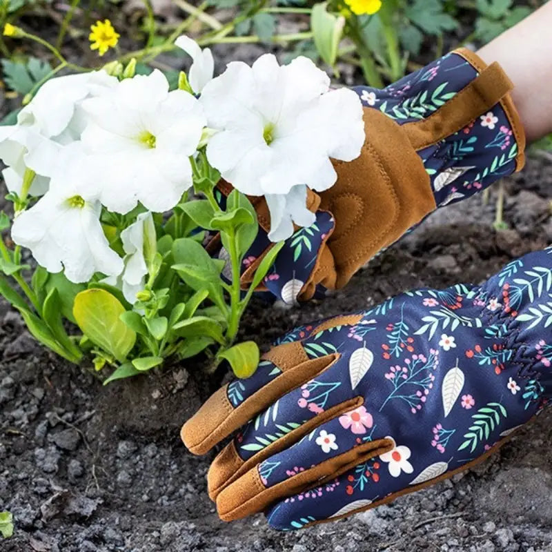Dark blue floral women gardening gloves with breathable thorn proof leather and tan leather accents shown from the back side.