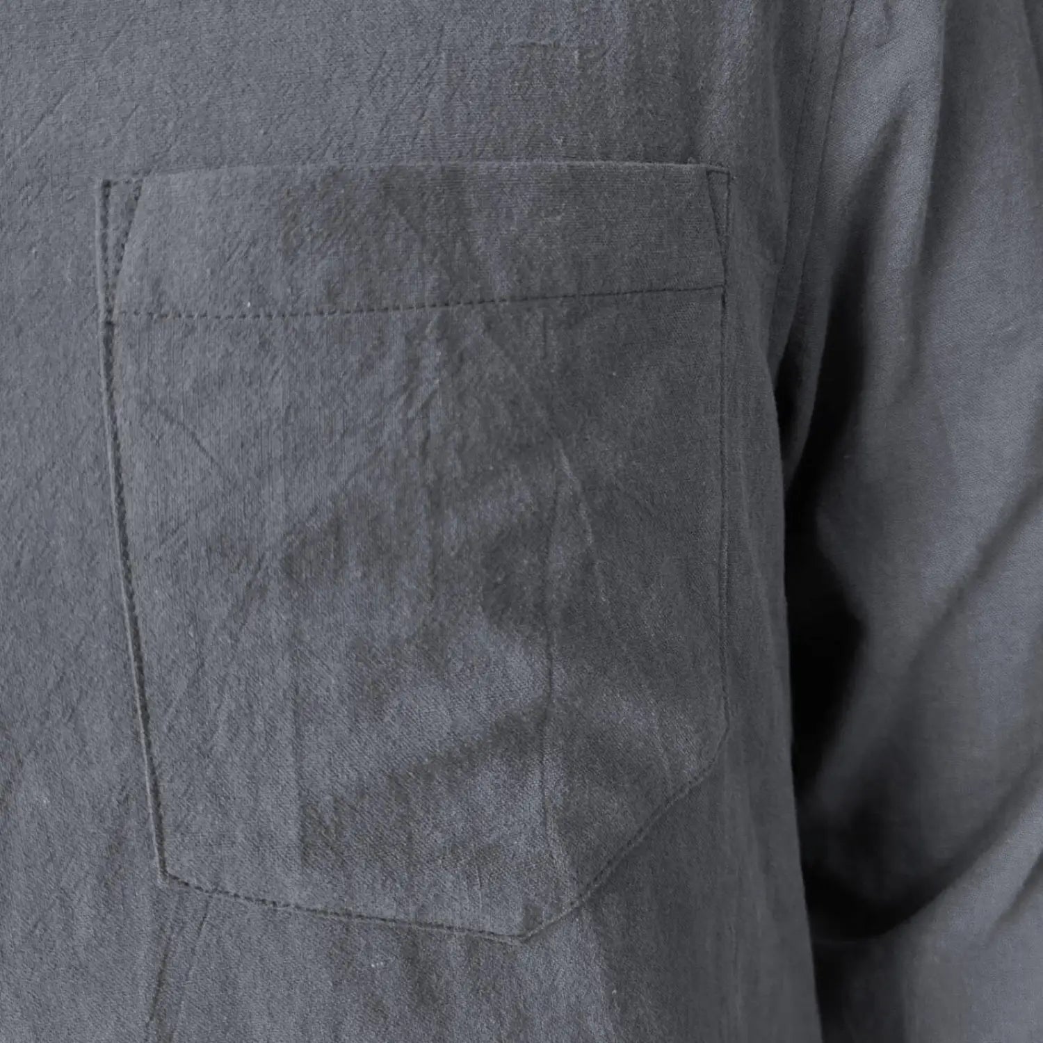 gray textured fabric chest pocket with visible stitching on a men linen blend casual shirt