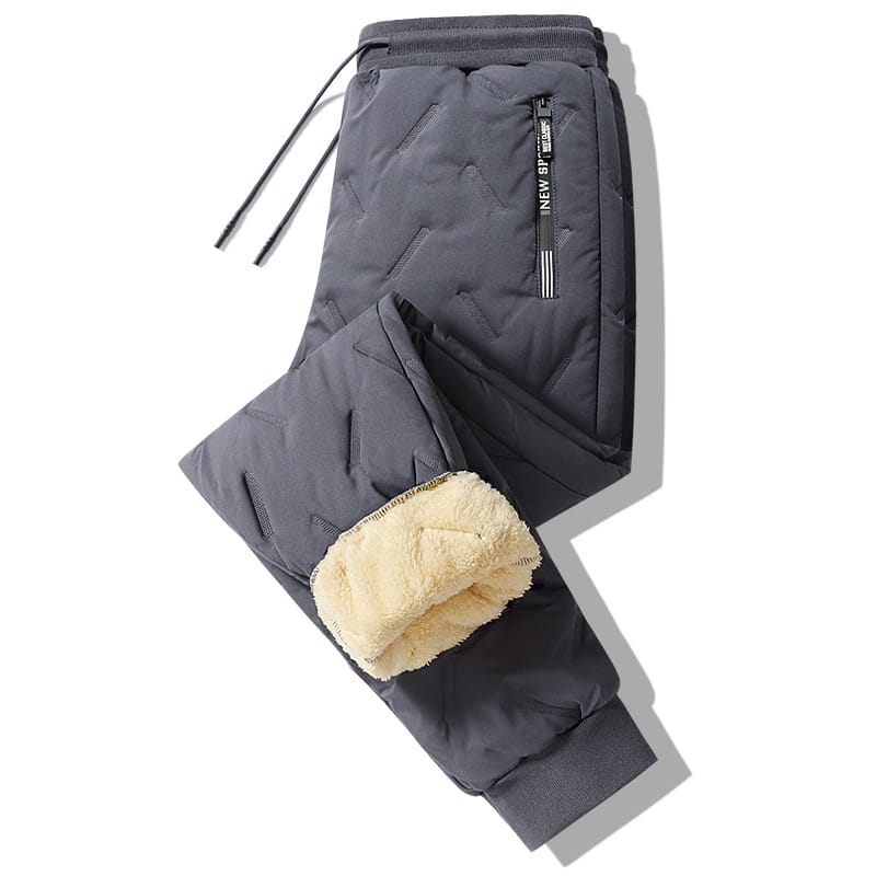Men fleece lined thermal sweatpants in dark gray quilted fabric with fleece lined cuffs and a drawstring waistband designed for waterproof winter wear.
