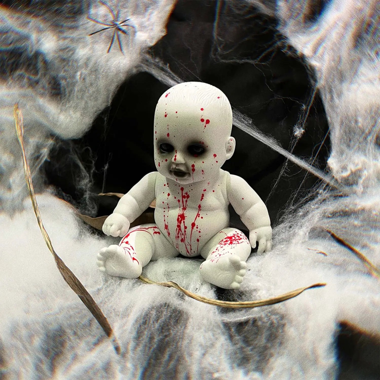 white plastic baby doll with red splatter paint design as a halloween hanging ghost doll spooky prop