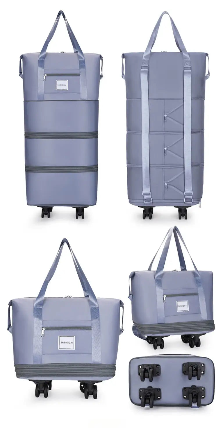 Un sac duffel roulant gris à grande capacité, avec plusieurs compartiments, des roues rétractables et des sangles réglables pour un usage en voyage.