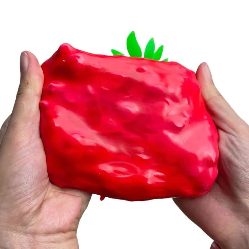 Jouet à mâcher et à malaxer en forme de fromage, en rouge vif, aspect fraise brillante, avec dessus vert feuillu, conçu pour soulager le stress et apaiser le stress lié au jouet.
