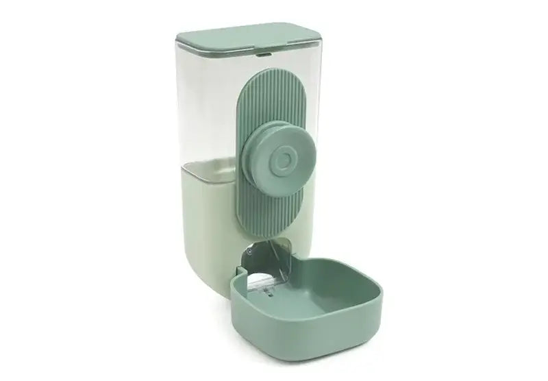 A sleek modern automatic pet feeder made of high-quality plastic with food storage features and sage green accents on the base control panel and feeding bowl and a translucent upper compartment.