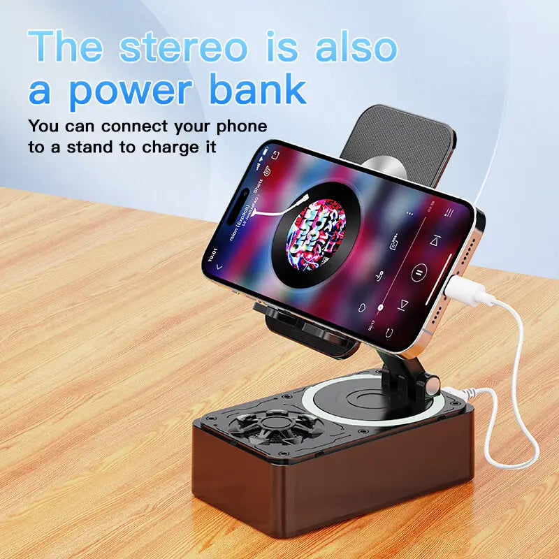 Black and silver bluetooth speaker phone stand for cell phone with built-in power bank functionality and charging capability.