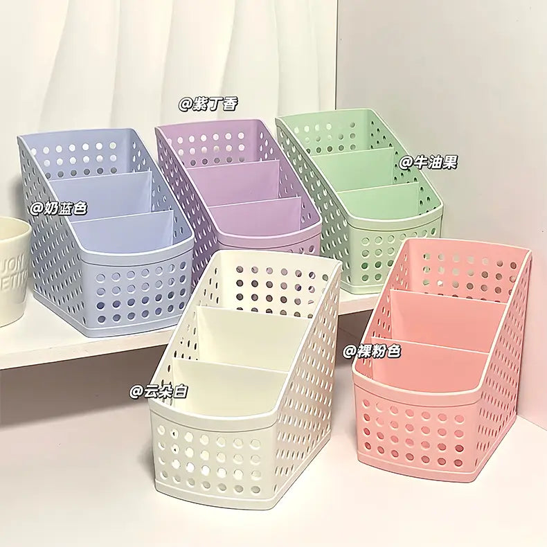 Pastel-colored plastic desktop stationery organizer with perforated sides and internal dividers for makeup and pen storage.