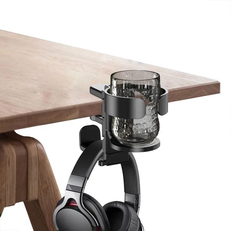 Black metal desk-mounted cup holder with headphone hook featuring a textured glass mug inside.