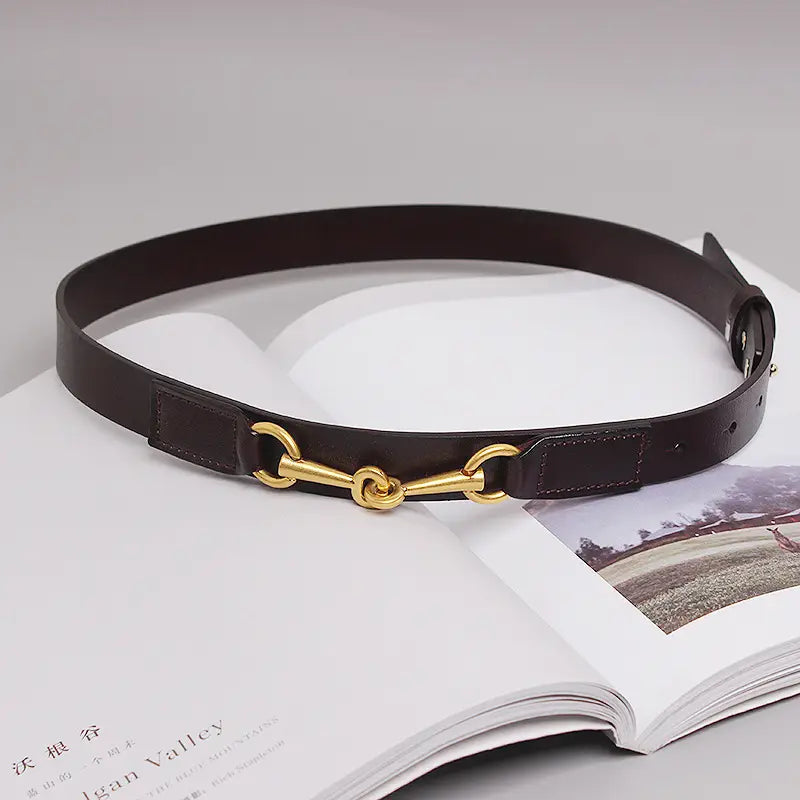 Dark brown leather women leather belt with gold-toned horsebit buckle.