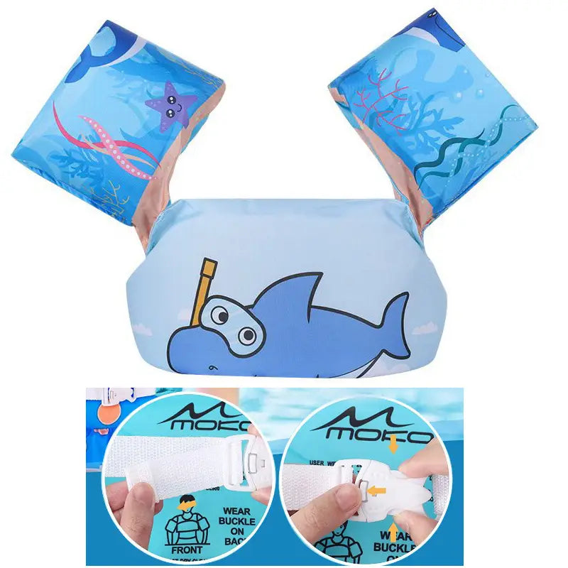 Kids swim armbands foam buoyancy float vest in blue inflatable foam with a cartoon shark design and ocean-themed patterns.