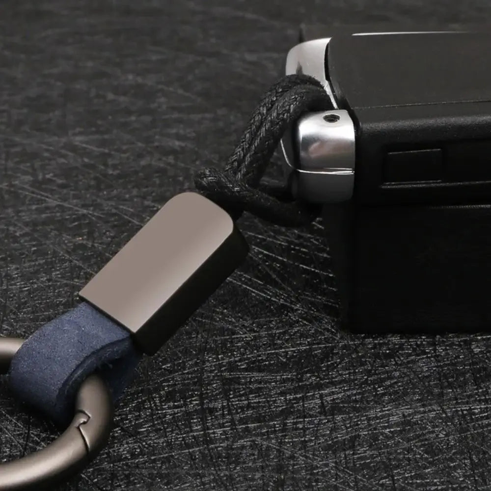 Leather carabiner keychain multifunctional key holder featuring a black braided cord with a matte finished metal clasp and navy blue leather loop.