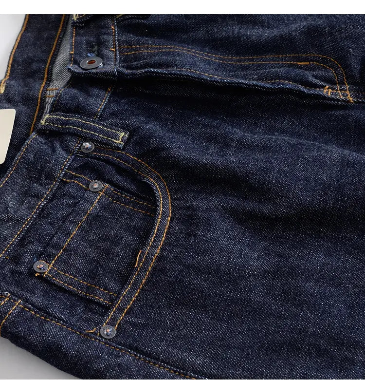 Heavyweight red selvedge denim jeans in dark indigo with contrasting yellow stitching and silver-toned buttons.