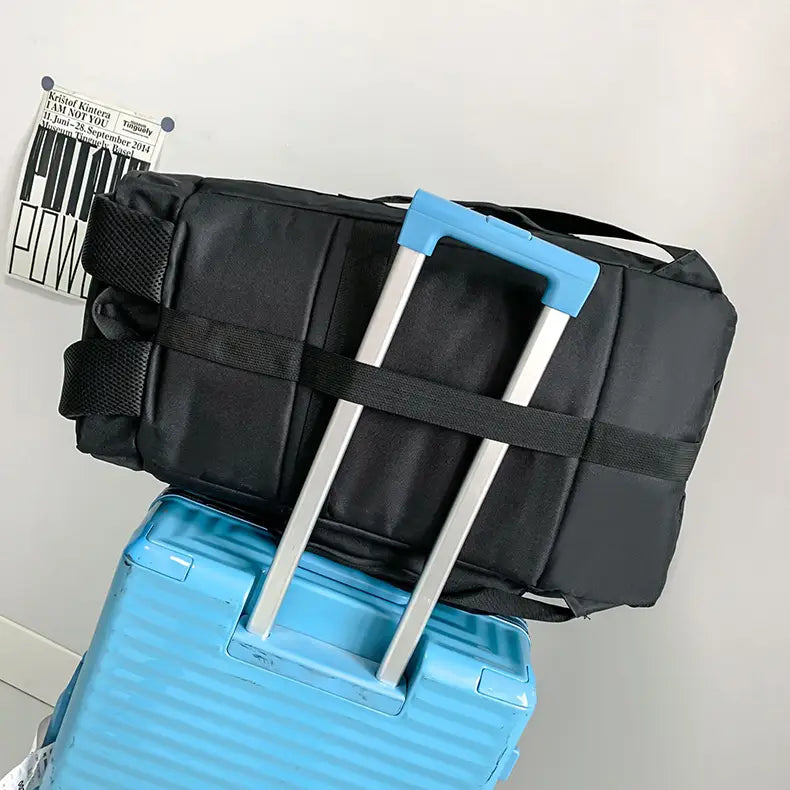 Black waterproof gym backpack and travel duffel bag with blue handle and silver telescoping poles.