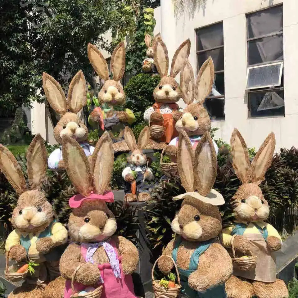 A collection of 35cm brown plush straw Easter rabbit figurines dressed in colorful outfits holding baskets.