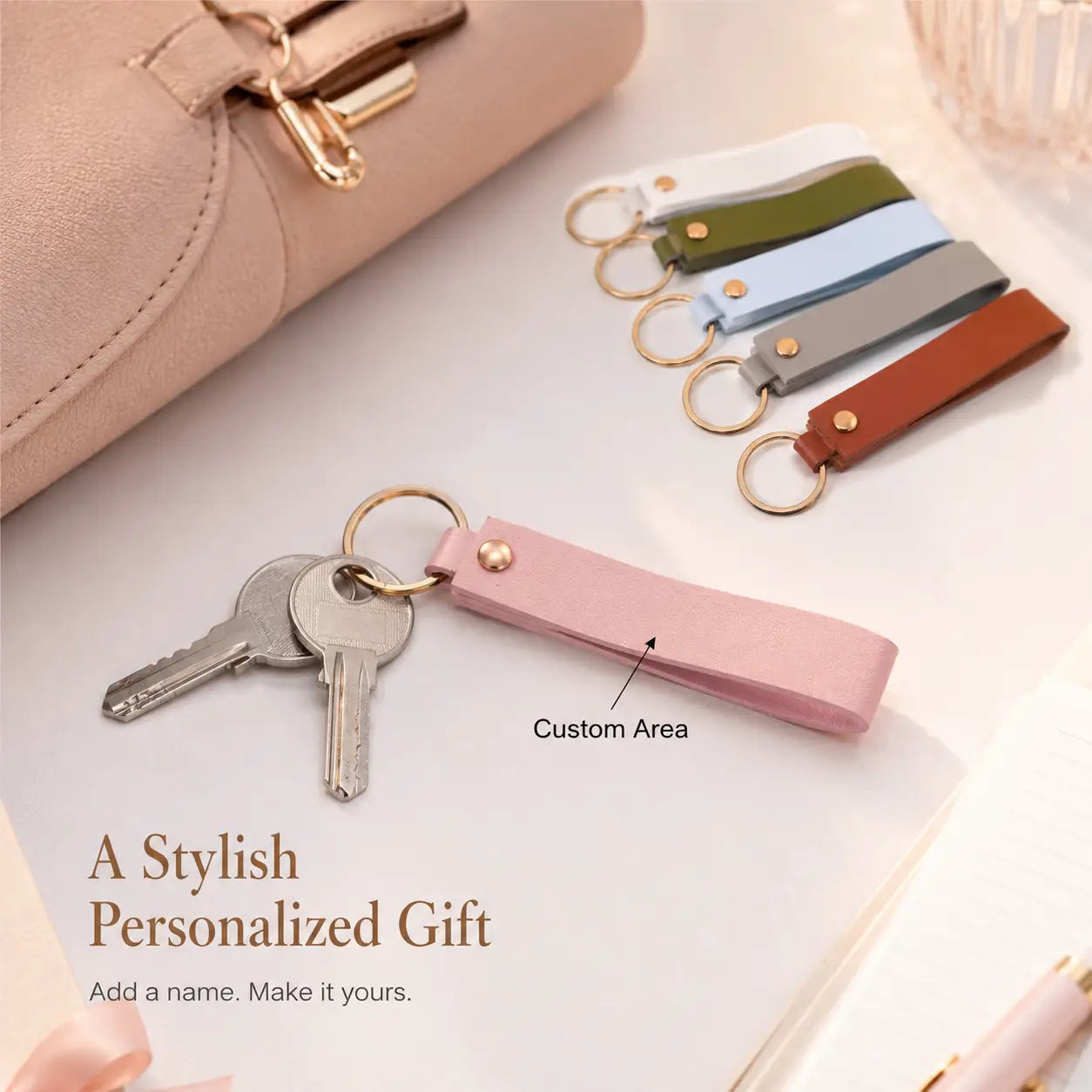 Custom name pink leather keychain featuring a gold-tone metal ring and button.